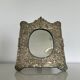 Baroque mirror in repoussé brass