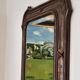 Italian sculpted mirror, patinated brown and gold wood, architectural frame from the 1960s.