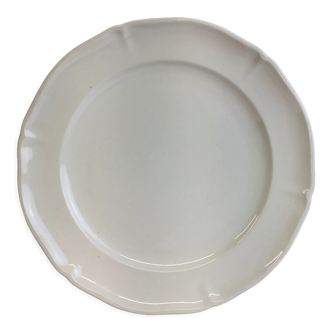 Old dish of ivory color and round shape with a chantourné edge.