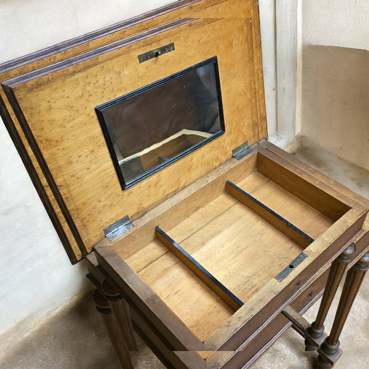 Antique wooden work table, inlaid top and interior mirror.
