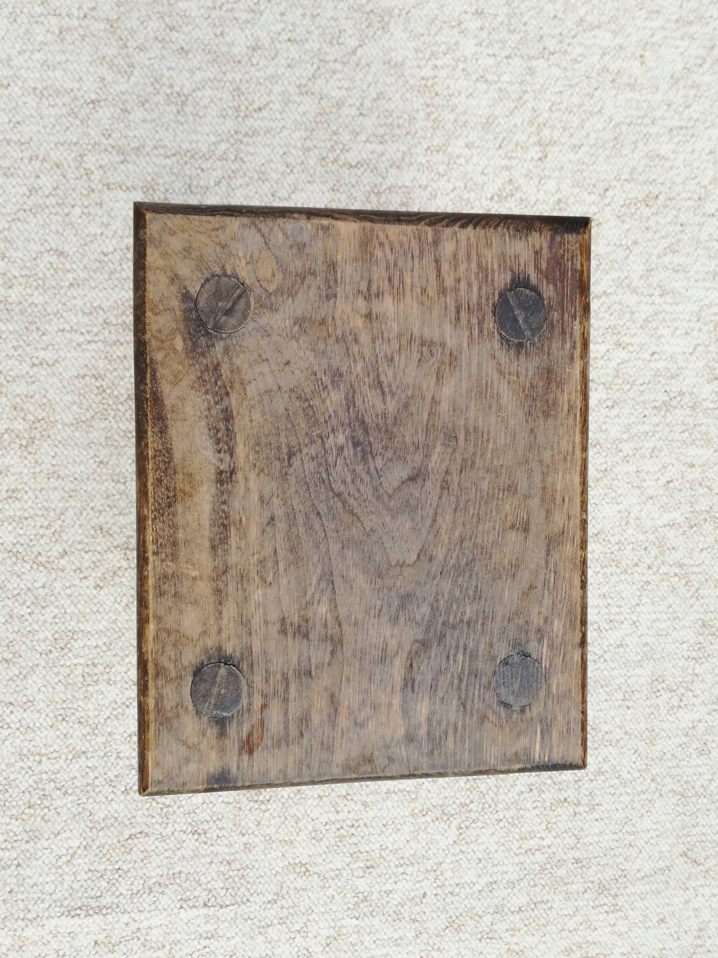 Old wooden stool with log feet