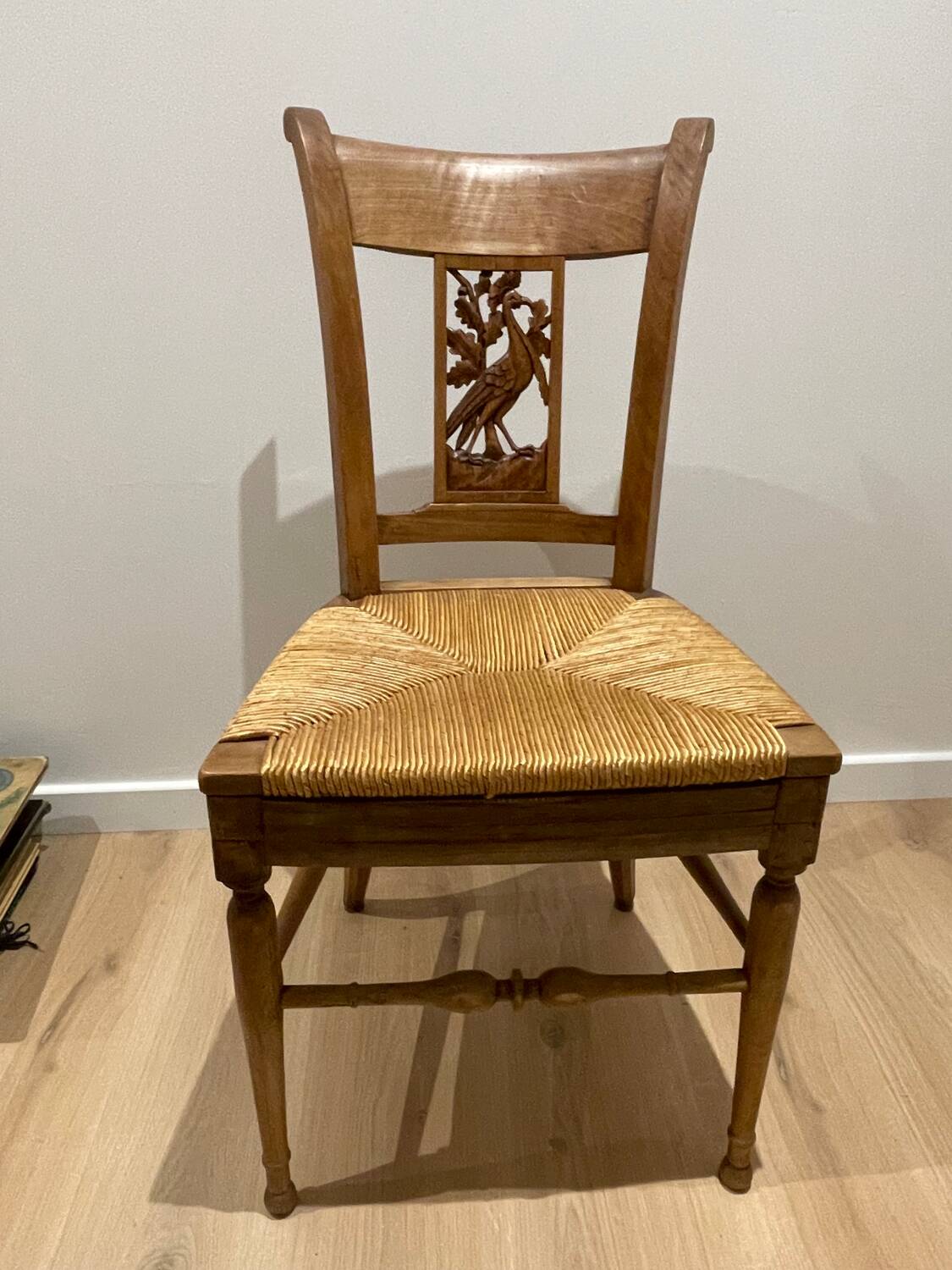19th century straw chair with carved peacock back