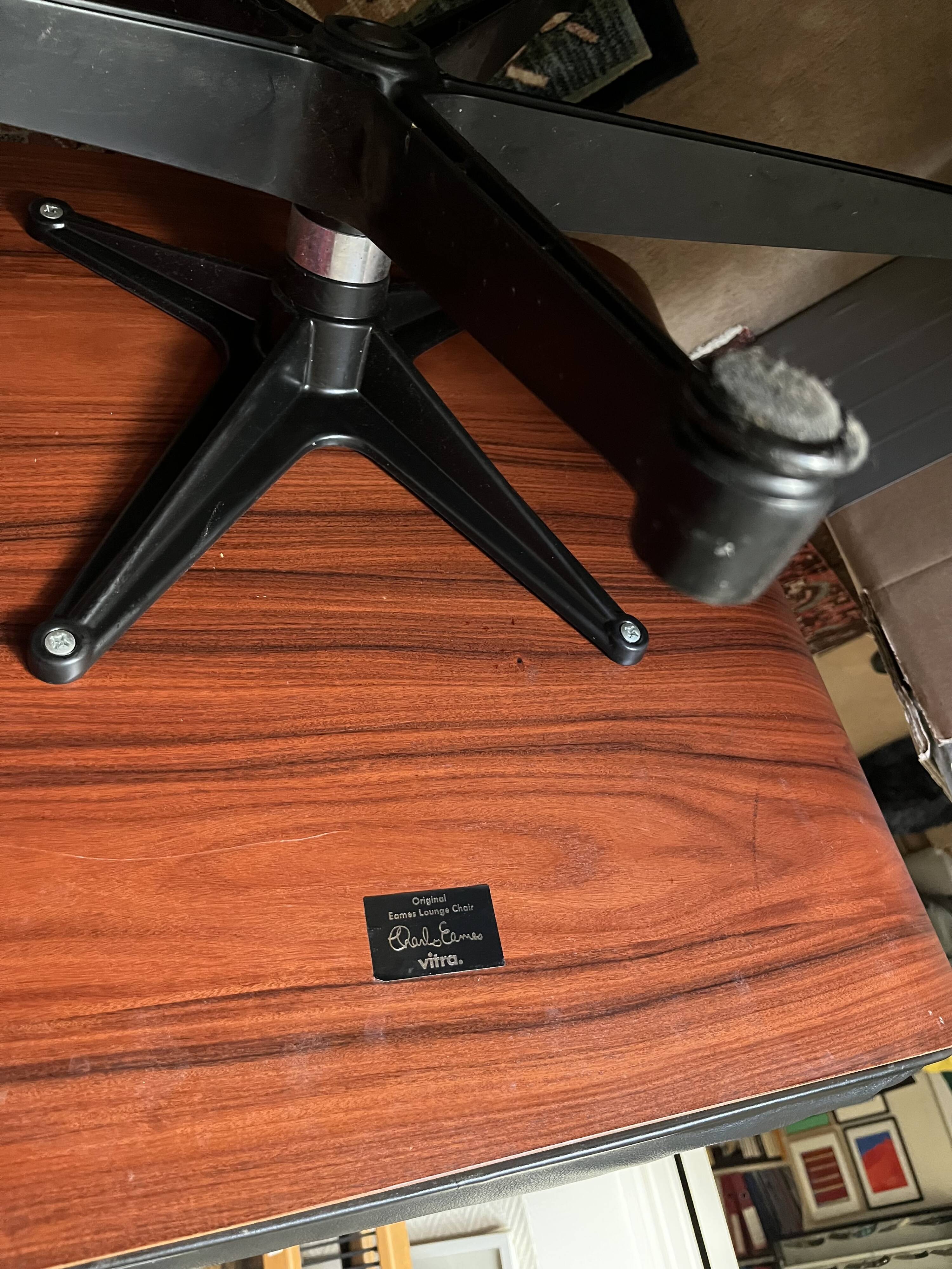 Black leather Eames Vitra armchair, original with rosewood ottoman.