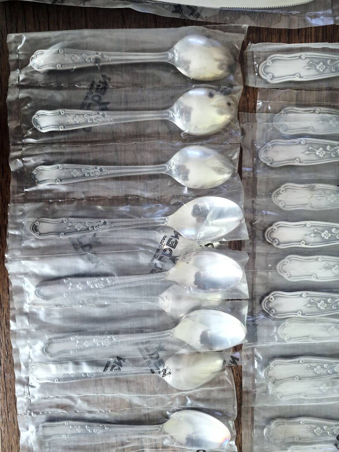 48 new silver-plated metal cutlery pieces in blister packaging.
