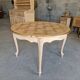 Round table made of cherry wood, sanded and varnished.