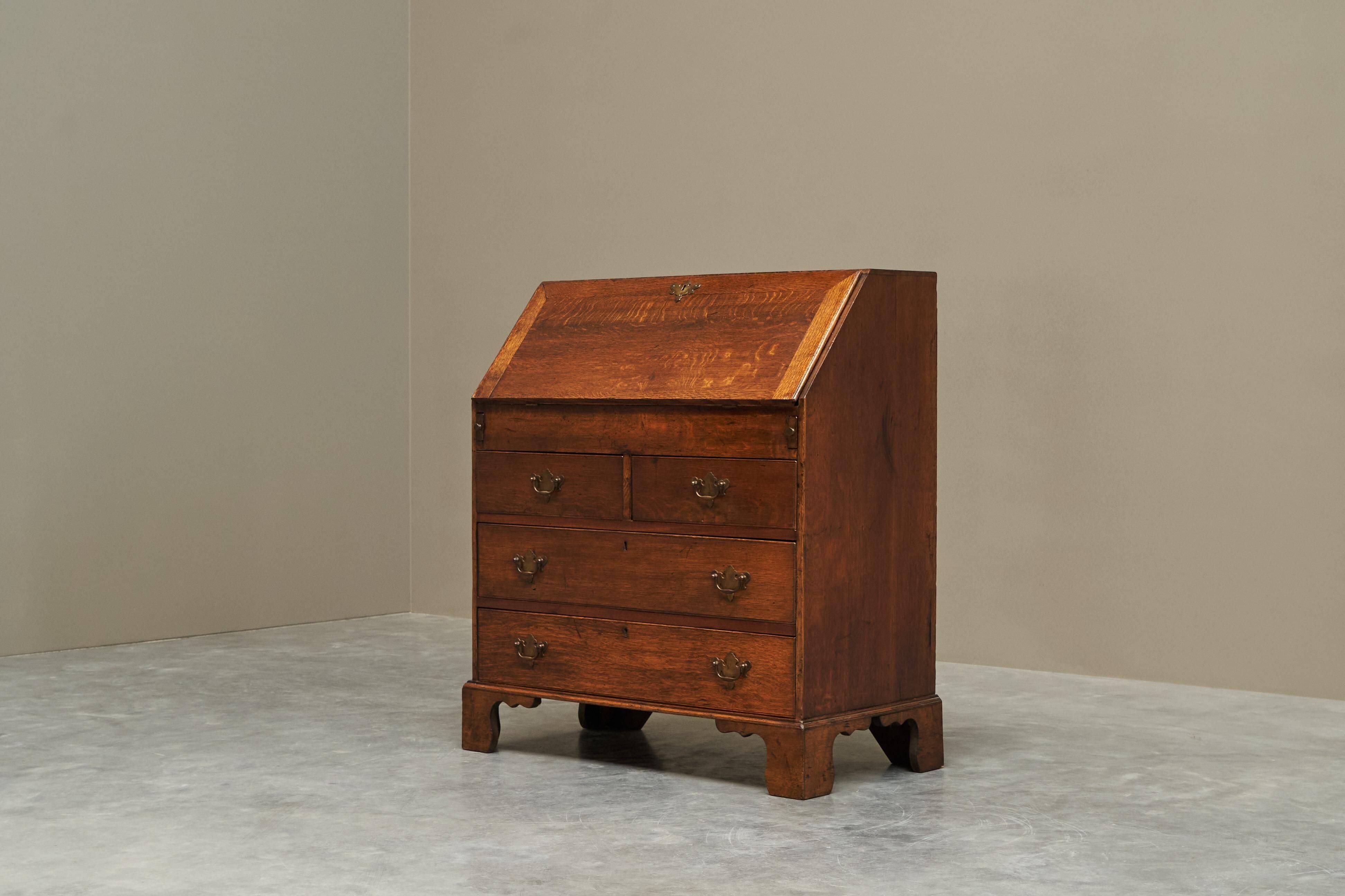 Antique English oak secretary with drop-down front.