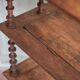 Napoleon III spool shelf, floor-standing shelf with brass tips.