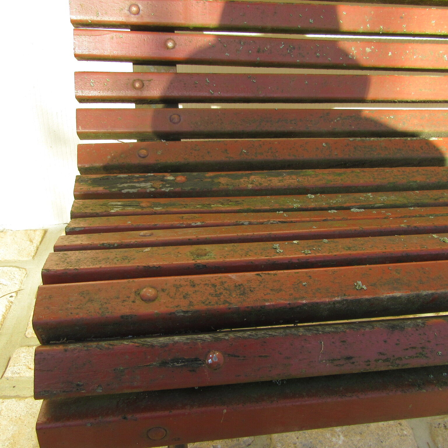 Public bench in wooden slats and cast iron legs
