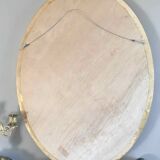 Beveled oval mirror with carved gilded wood frame