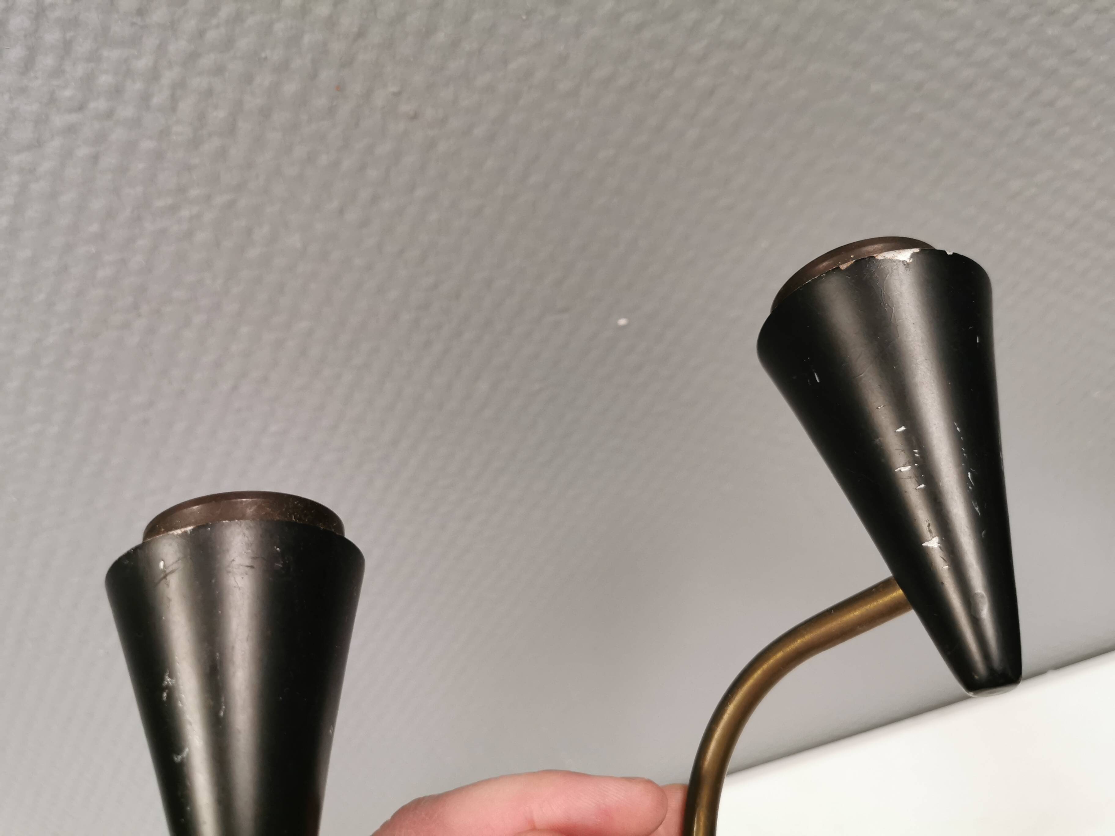 A set of wall lamps in black lacquered metal with brass details