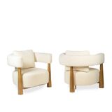 Pair of “bean” shaped armchairs, in blond beech. Contemporary work.
