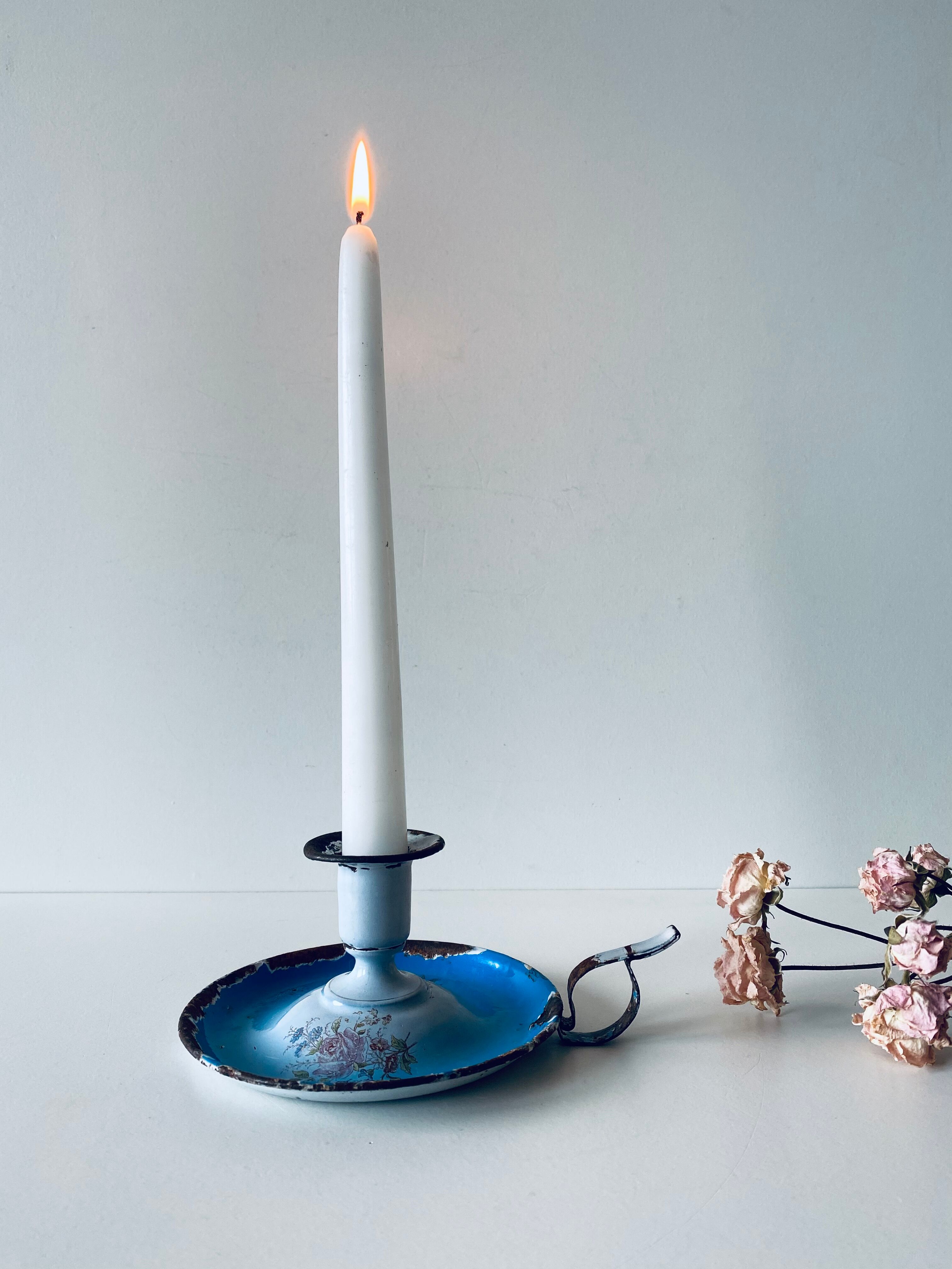 Old enamelled metal candlestick