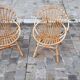 Pairs of shell rattan armchairs from the 50