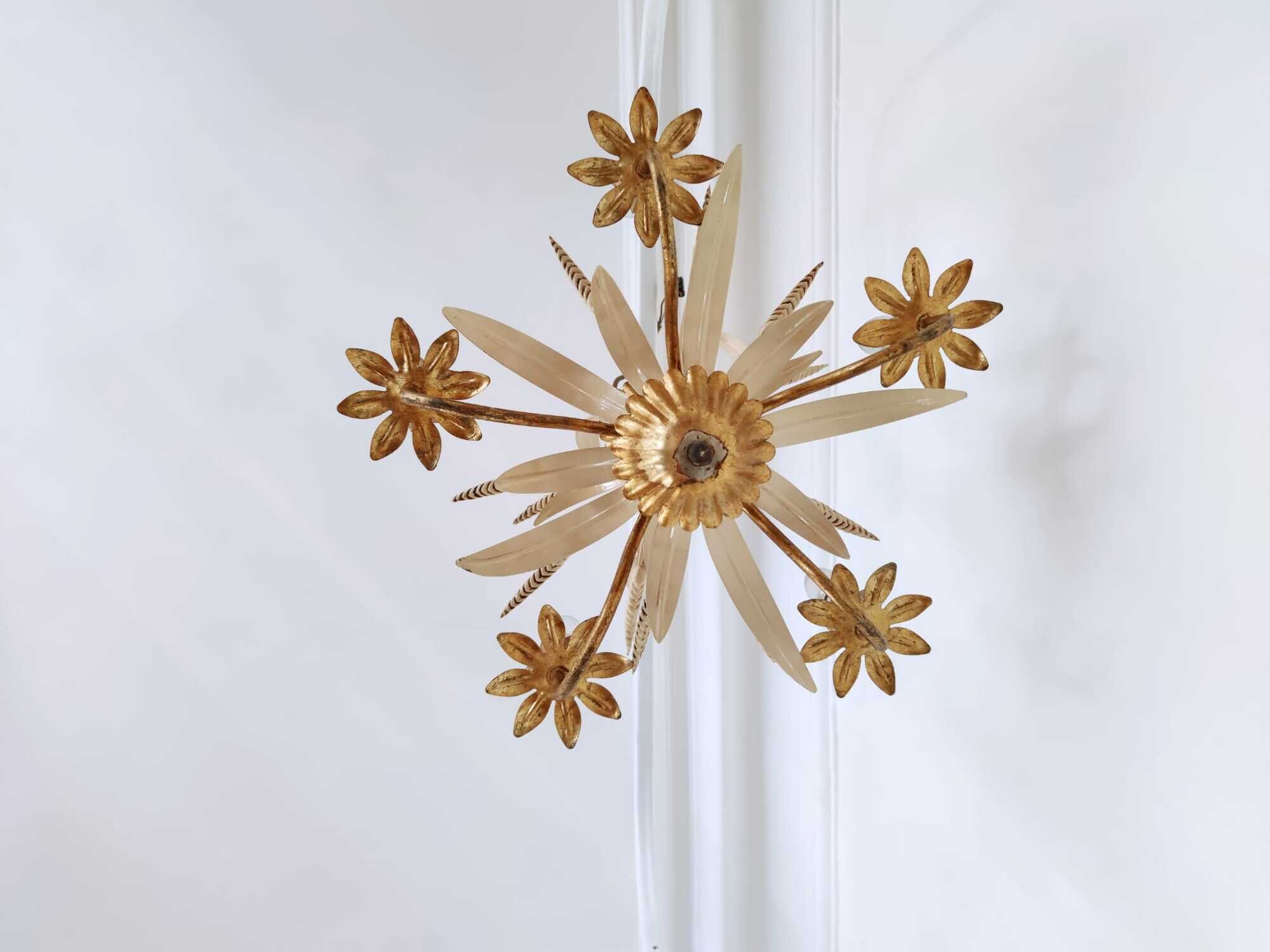 Vintage wrought iron chandelier decorated with golden and beige reeds