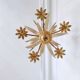 Vintage wrought iron chandelier decorated with golden and beige reeds