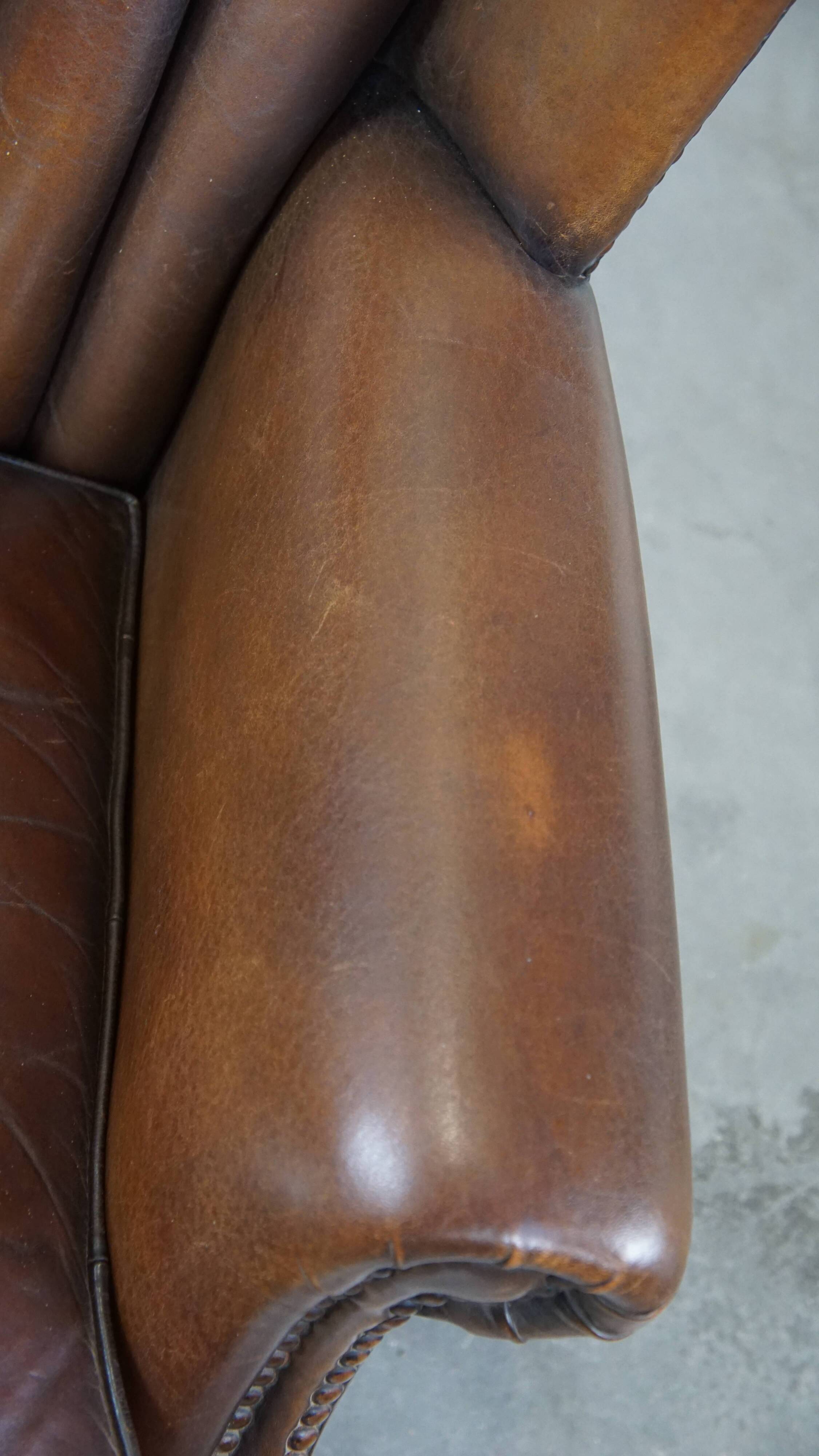 Sheep leather armchair finished with decorative nails