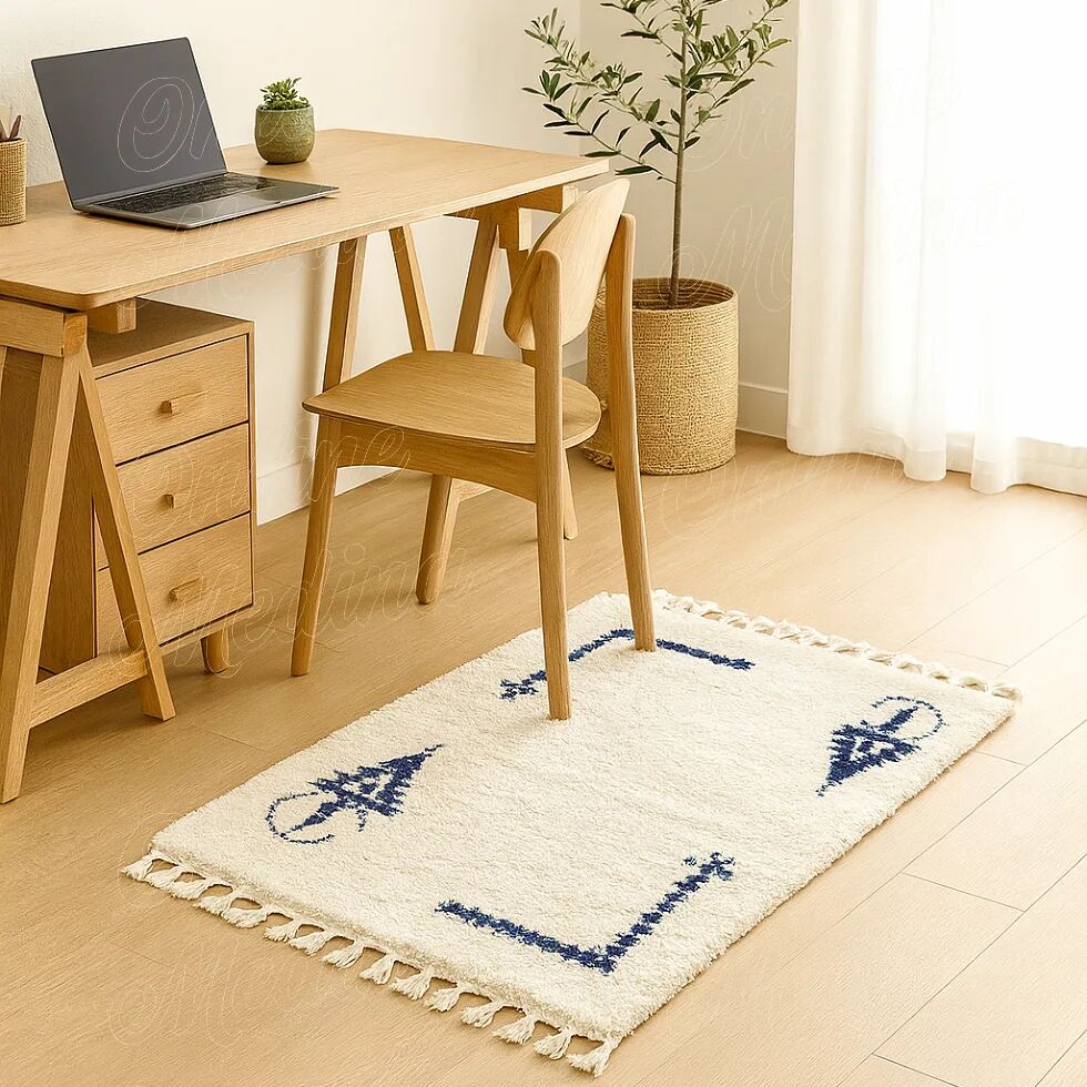 Ecru Berber rug with symbolic corner patterns.