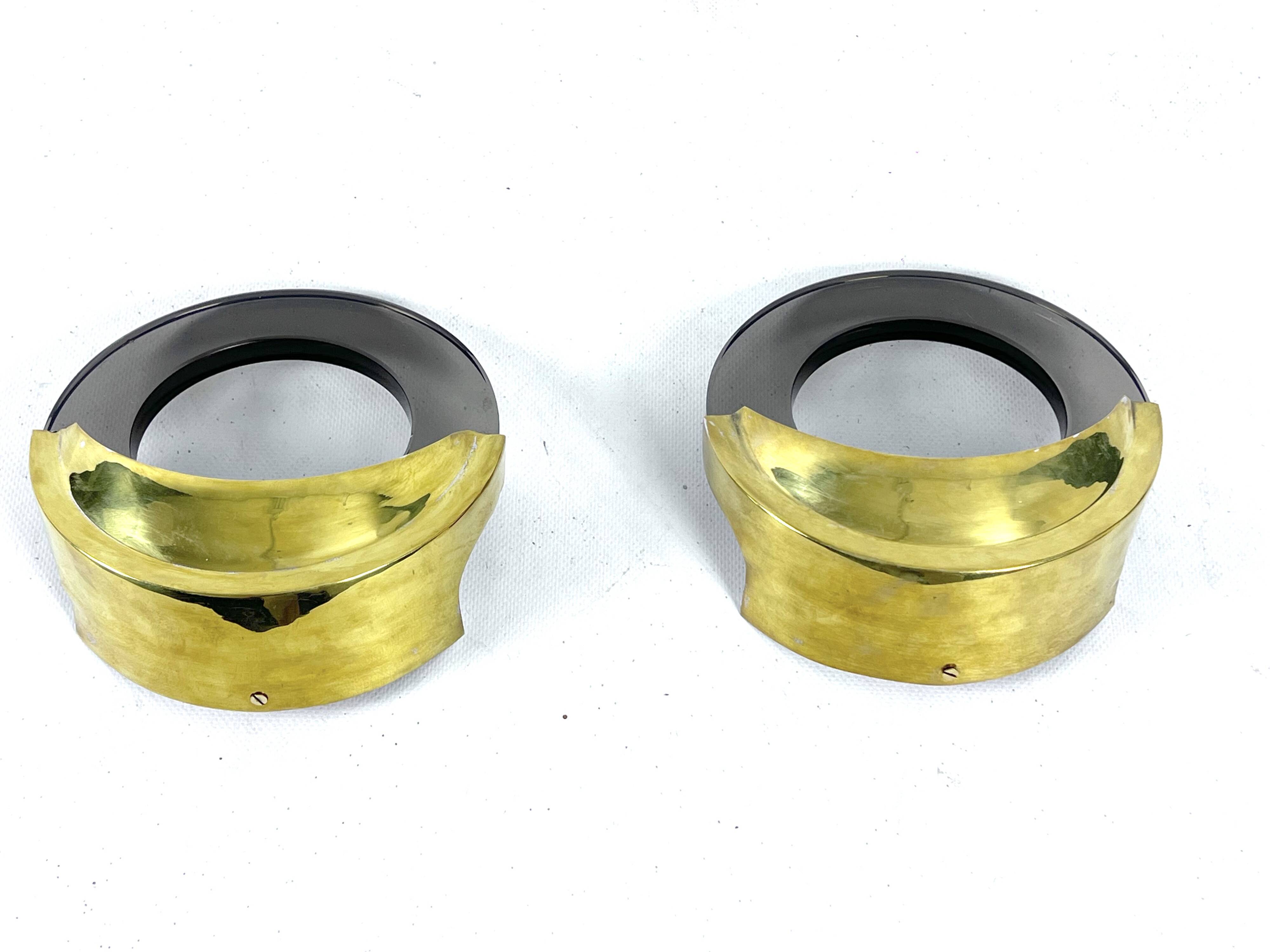 Mid-Century Modern pair of brass and thick smoked glass sconces. Italy 1970s