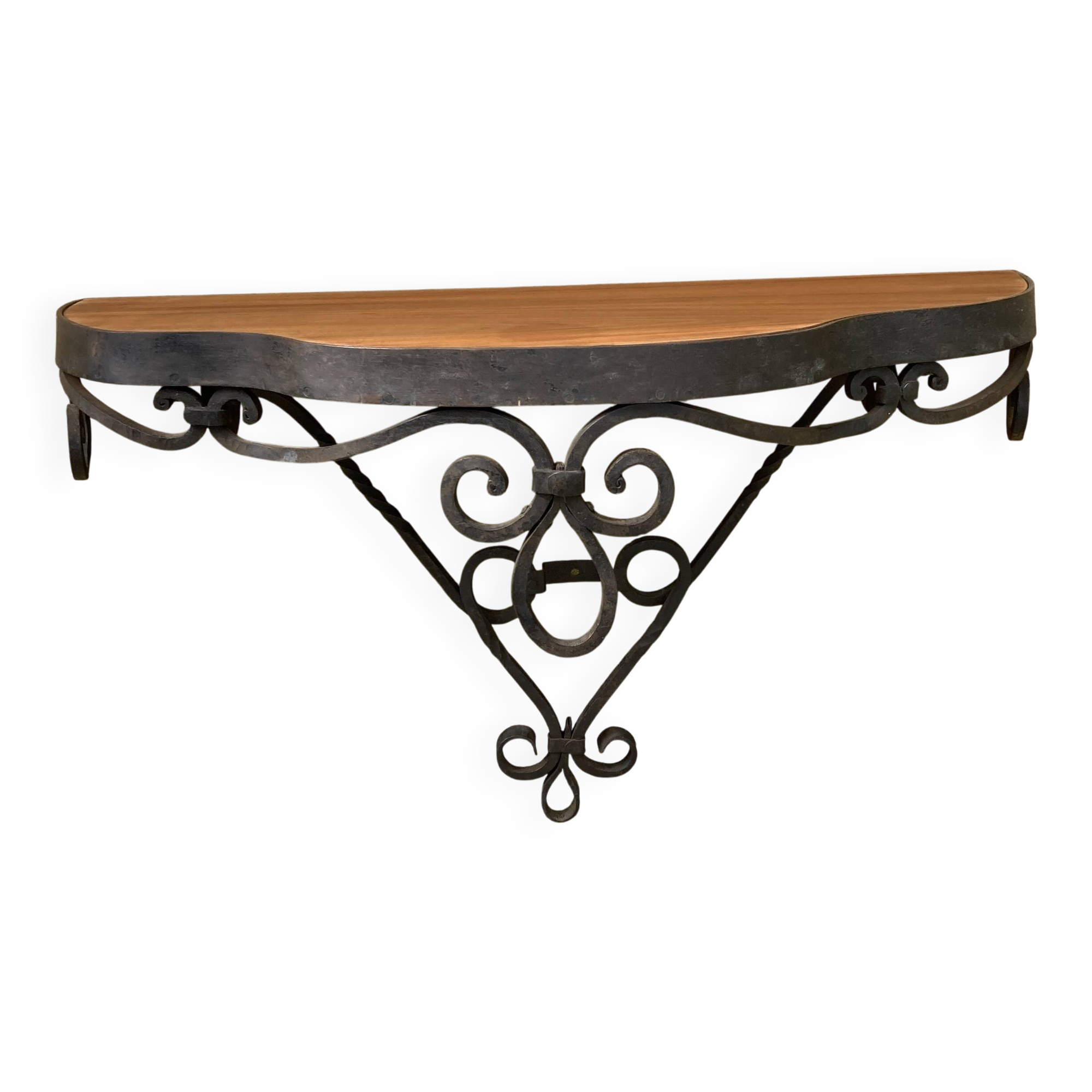 Old wrought iron console with a fleur-de-lis design.