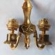 Wall lamp in gilded bronze with a lion's head and engraved globe.