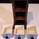 Storage in the form of a small wooden cabinet, with 3 ceramic drawers.
