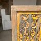Rectangular Indonesian construction element with blue and yellow plant in carved wood