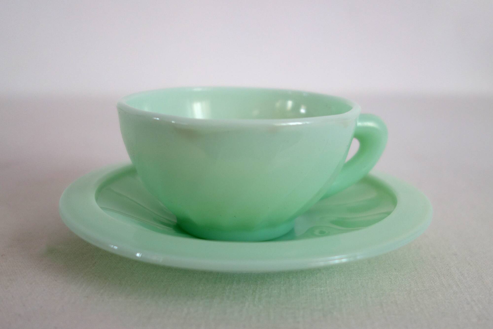 10 almond green opaline cups and saucers from the 50s