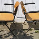 Pair of stackable class armchairs with Bakelite armrests