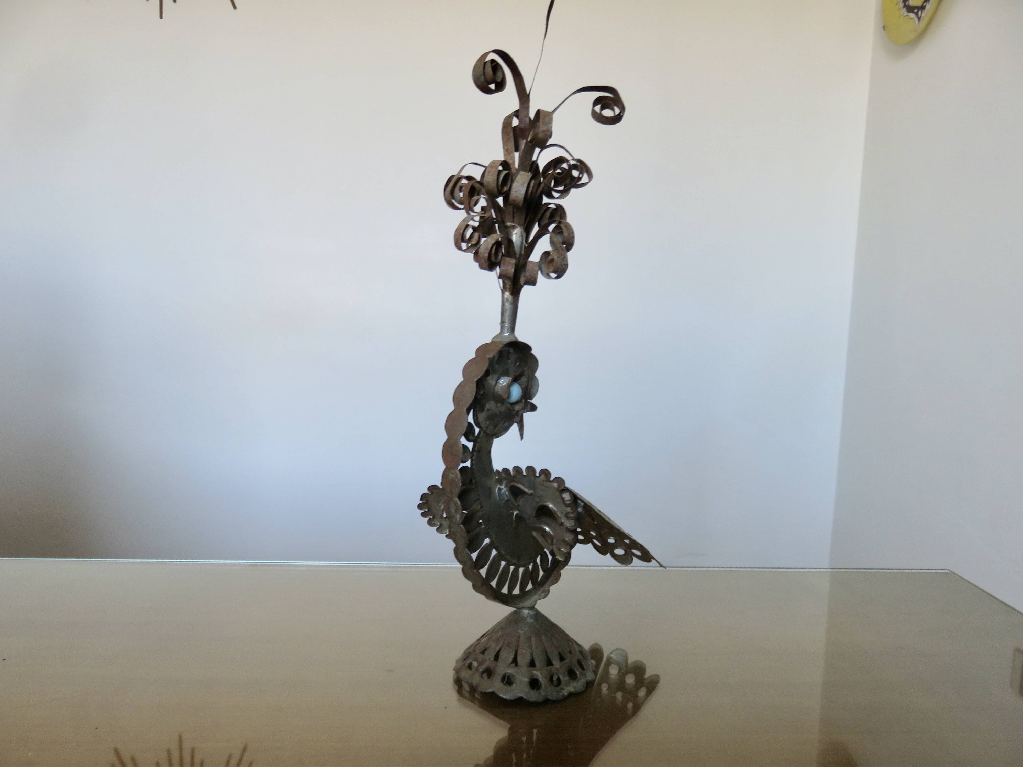 metal sculpture in sheet metal representing a peacock, work from the 1960s