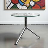 Modernist tripod side table in tempered glass and chrome metal.