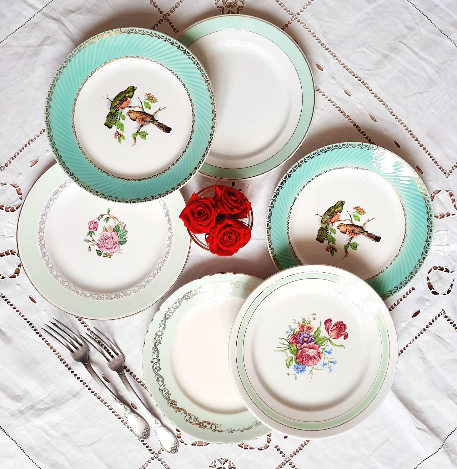 Old mismatched earthenware dinner plates accompanied by a deep dish