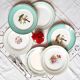 Old mismatched earthenware dinner plates accompanied by a deep dish
