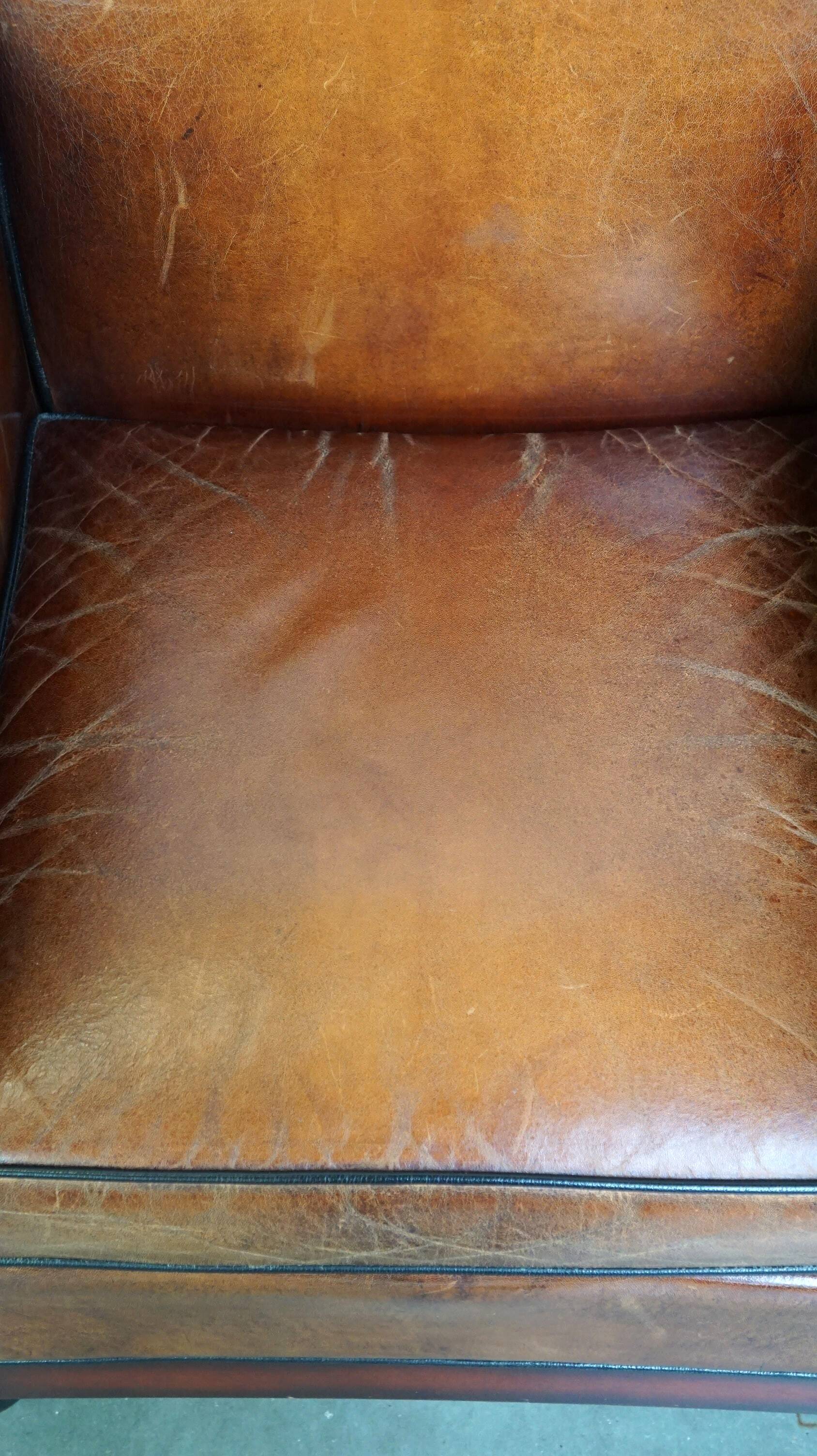 Sheepskin Art Deco design armchair with wood and beautiful cognac-colored leather