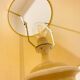1980s ceramic table lamp with a wooden base and adjustable shade.
