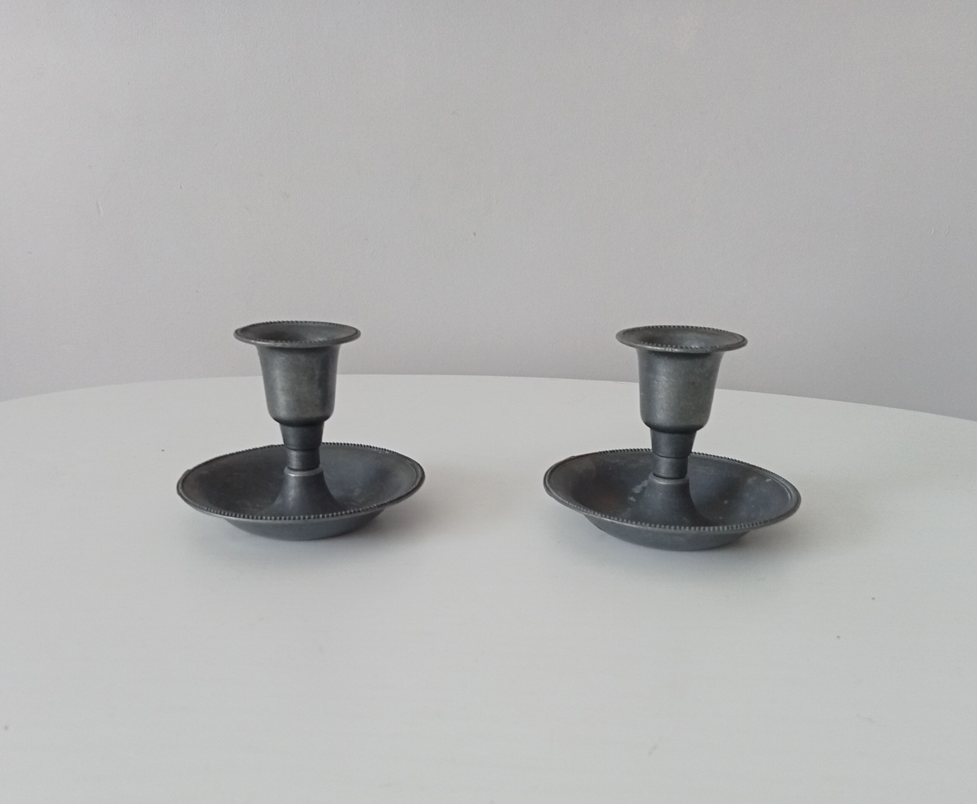 Pair of antique pewter candle holders