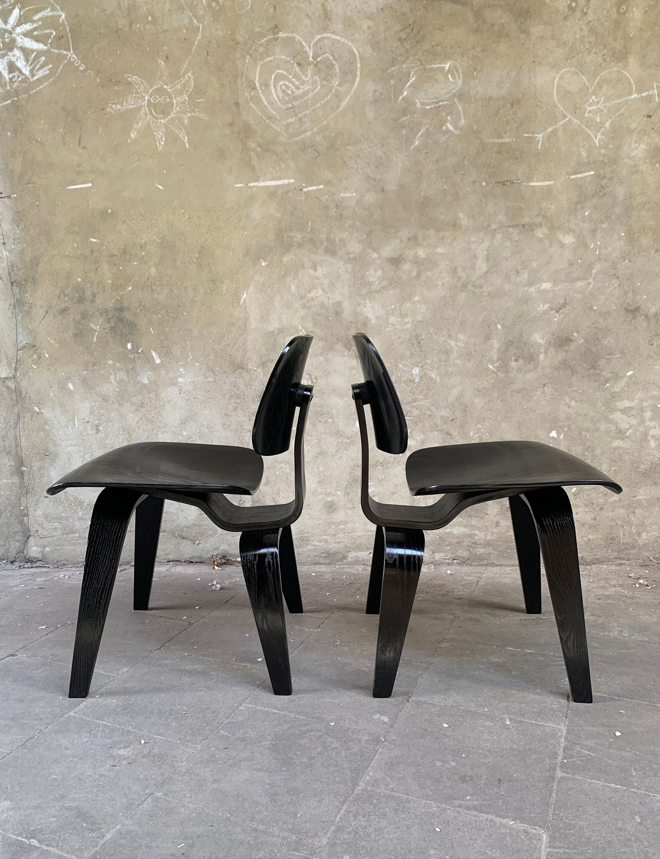 Pair of DCW chairs by Charles & Ray Eames in Black for Herman Miller 1950