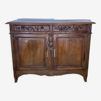 Low nineteenth century oak sideboard, richly carved with flowers