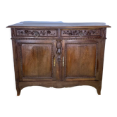 Low nineteenth century oak sideboard, richly carved with flowers