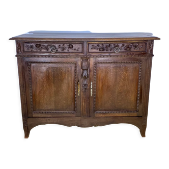 Low nineteenth century oak sideboard, richly carved with flowers