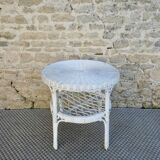Round white rattan side table with storage underneath, circa 1970.