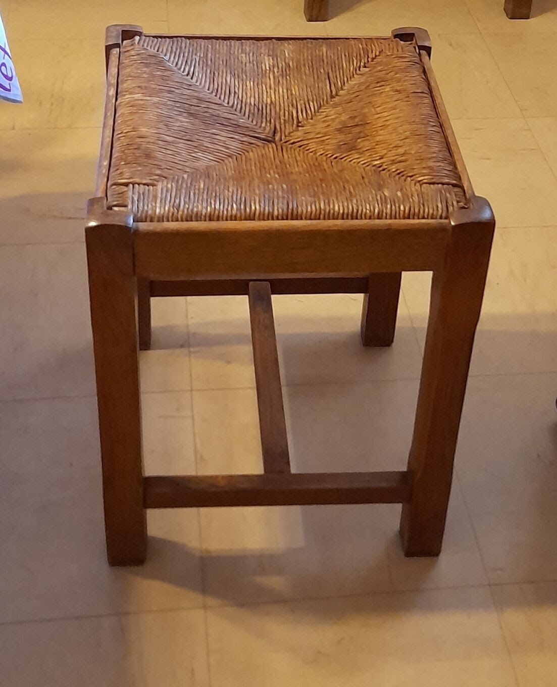 Oak stool seated in straw
