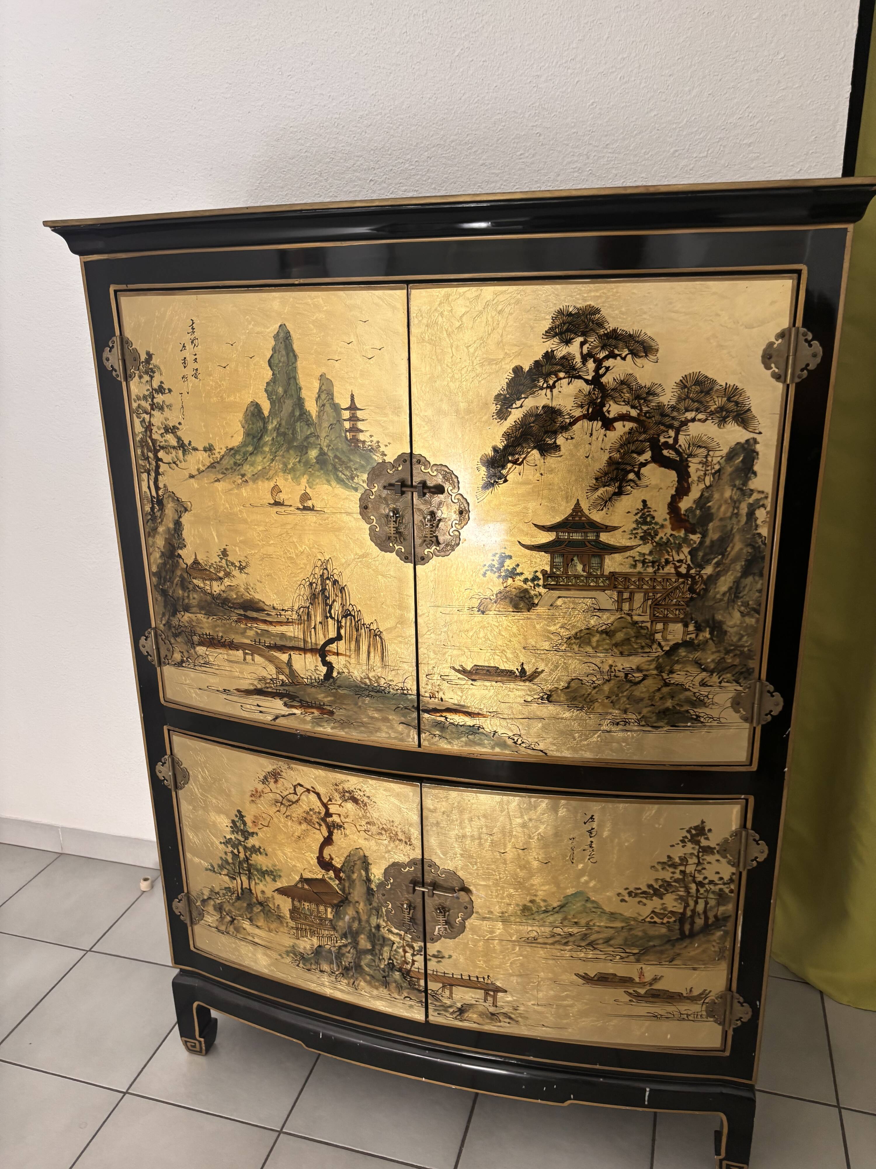 Curved bar cabinet inspired by Chinese design, black lacquer and red interior.