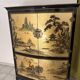 Curved bar cabinet inspired by Chinese design, black lacquer and red interior.