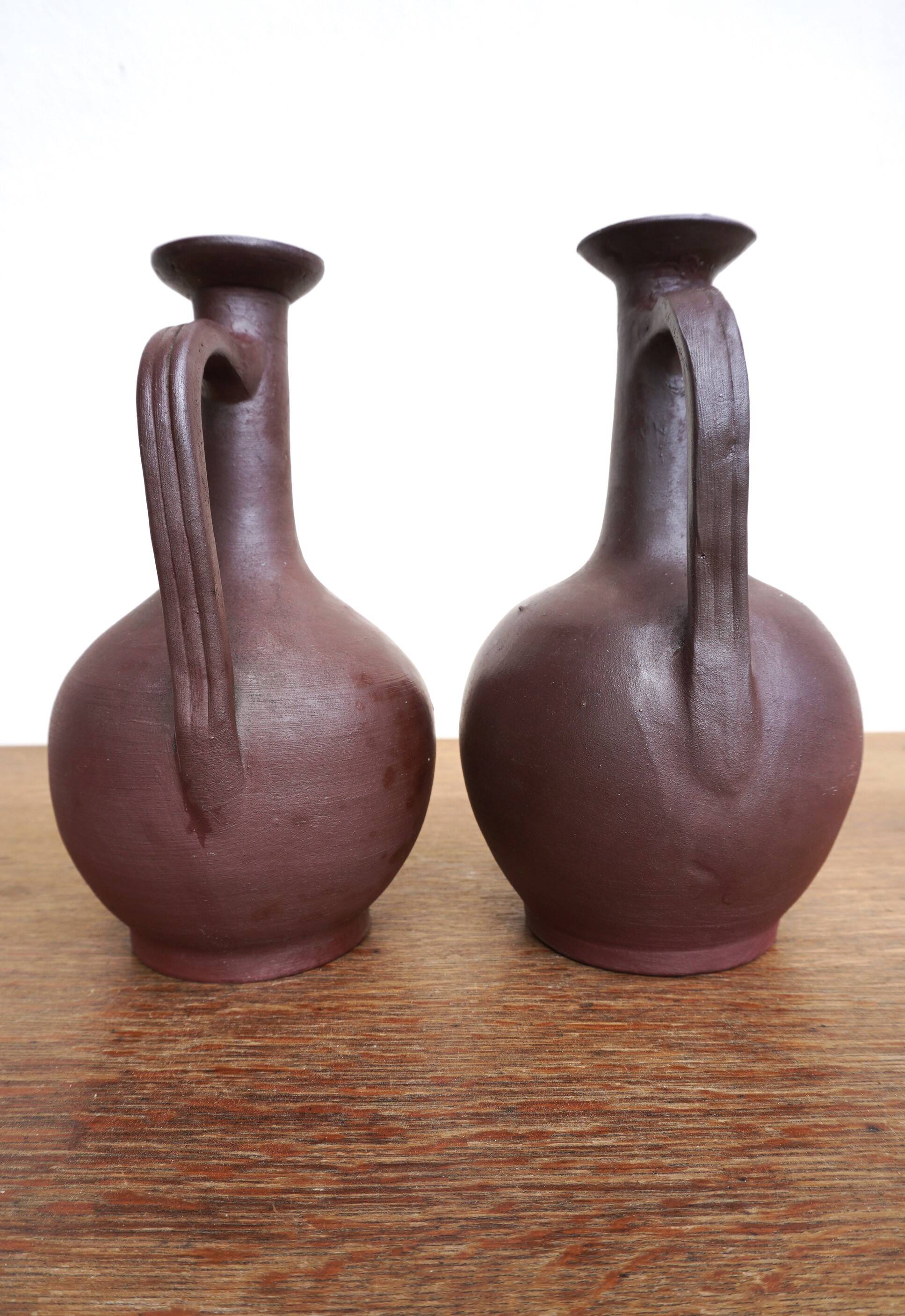 pair of terracotta bottles or carafes