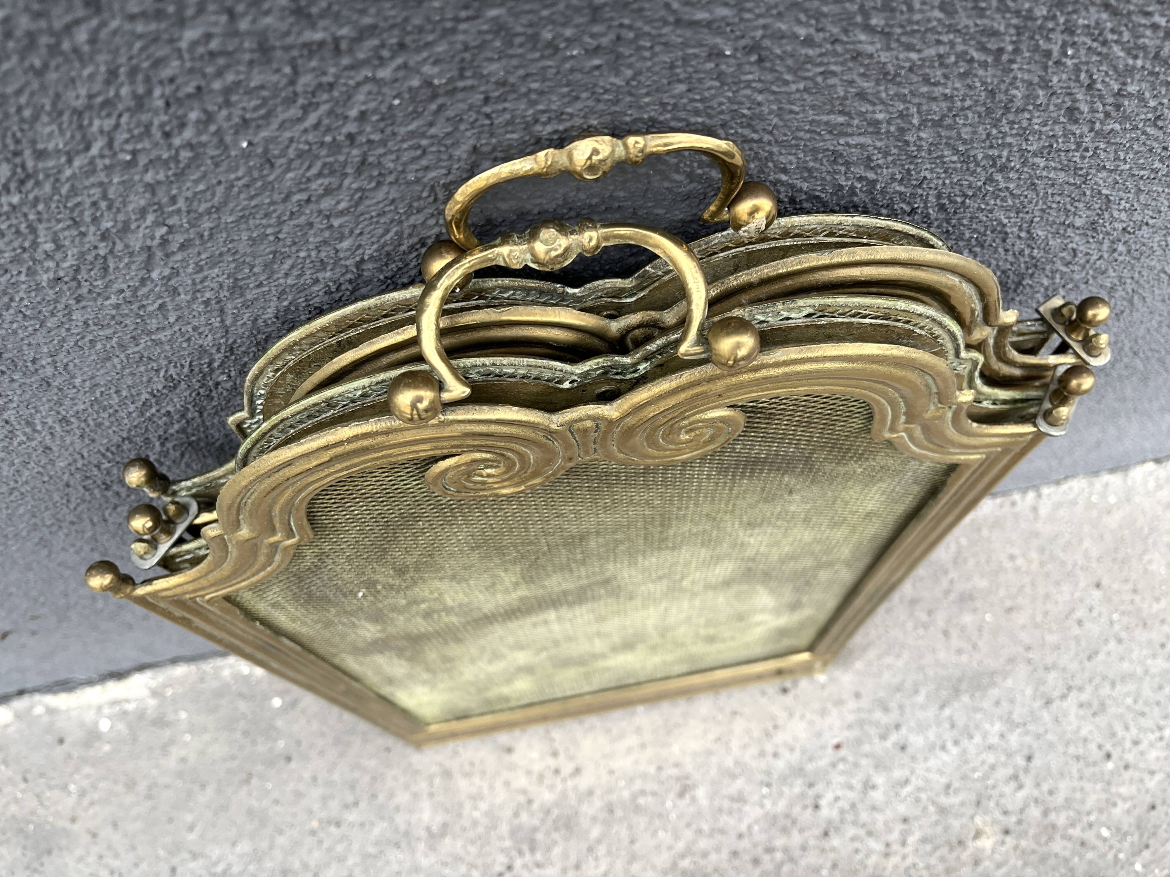 Antique brass fireplace screen from 1920, vintage spark guard.