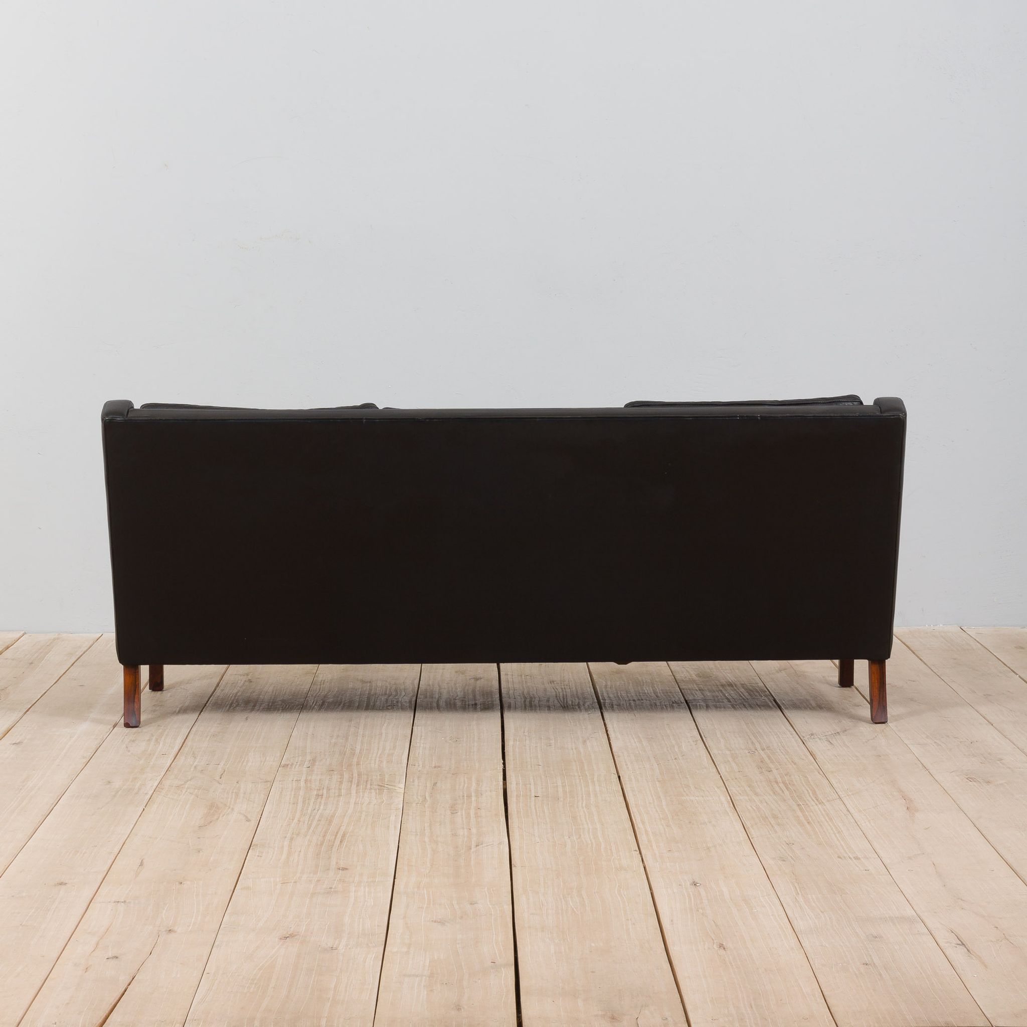 Danish black leather and rosewood sofa
