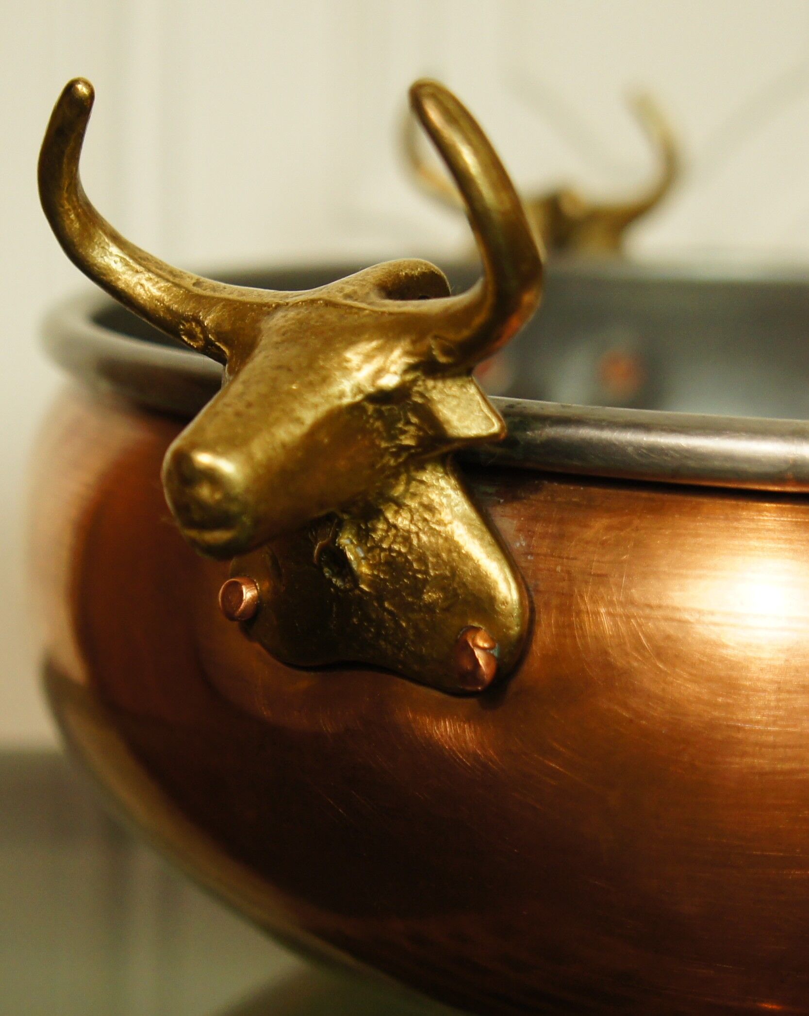 Copper cauldron with golden bronze bull heads