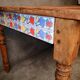 Small farmhouse table in light wood and tiled floors
