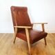 Fauteuil 70 en skaï marron et structure bois