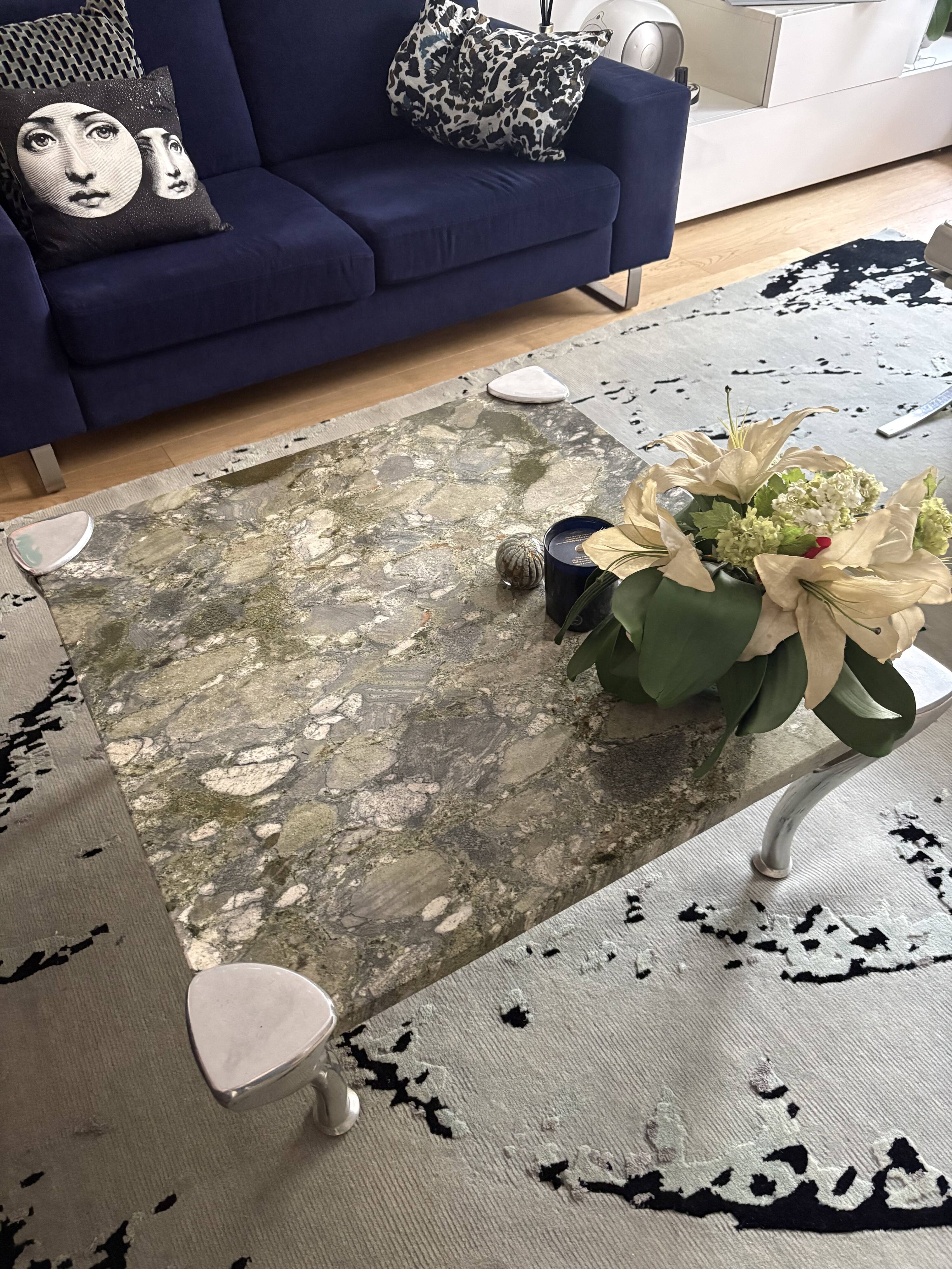 Contemporary coffee table with a marble top and steel base.